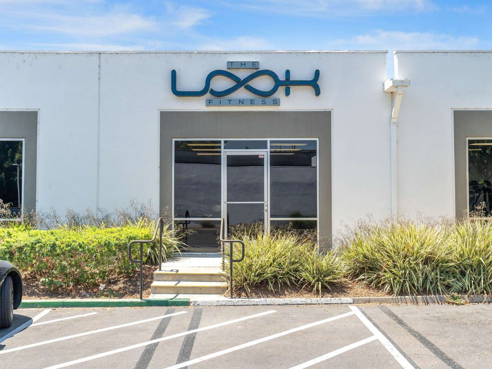 The entrance to The LOOK Fitness at 19732 MacArthur Blvd, with parking directly in front of the door