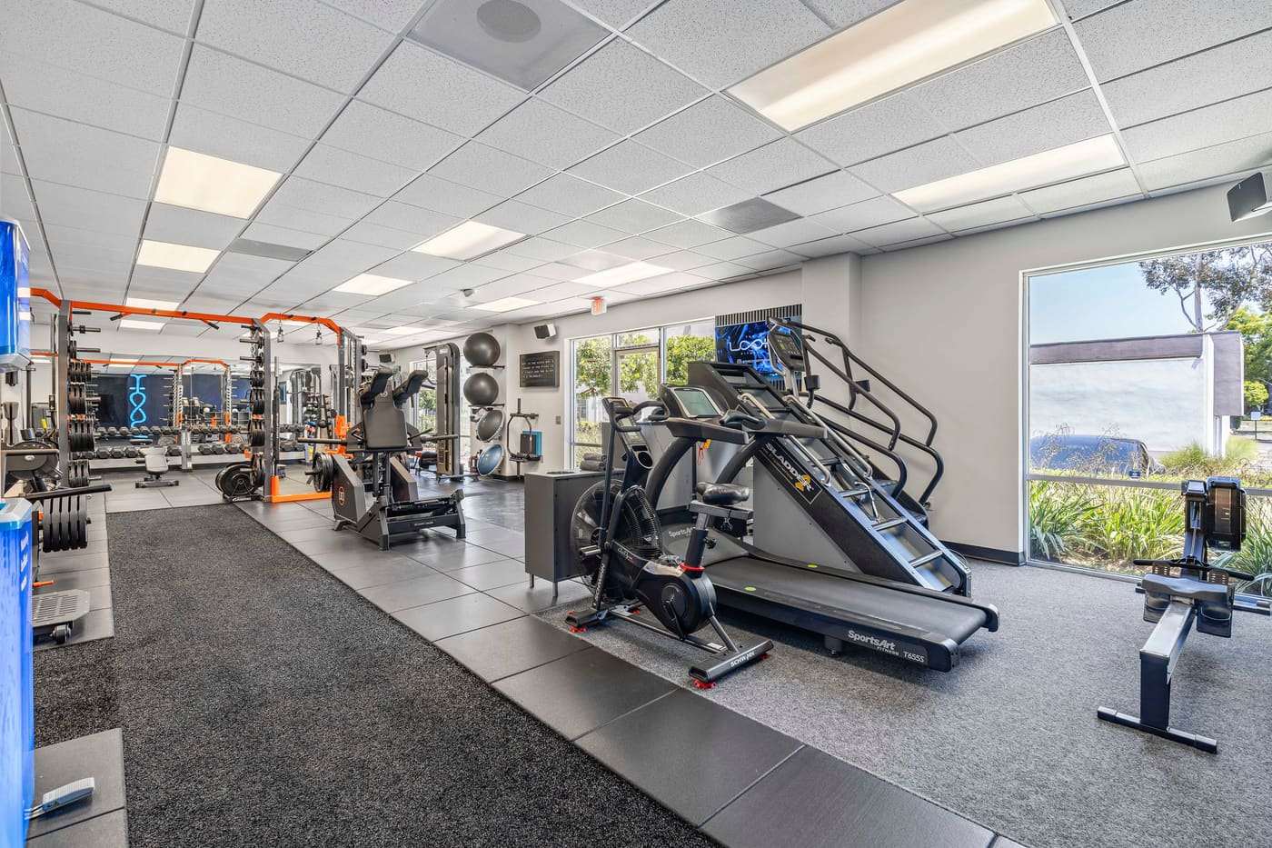 Treadmills and conditioning equipment beside the racks at The LOOK